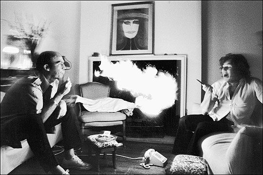 Hunter S. Thompson exhaling lighter fluid at Jann Wenner, at Wenner's New York home . Annie Liebovitz 1976, Contact Press Images