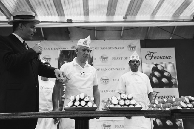 Cannoli Eating Competition, Annual Feast of San Gennaro, Little Italy; Leica M6 TTL 0.58, 35mm Summicron, Kodak Tri-x 400 © Doug Kim