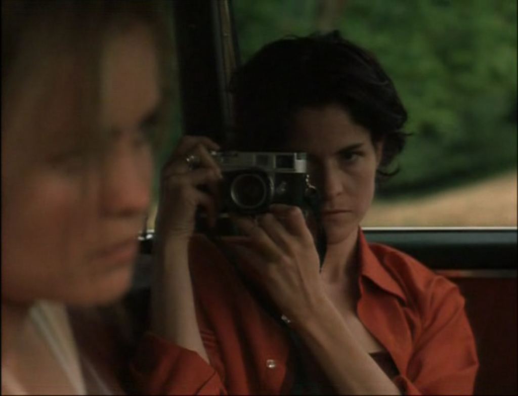 Ally Sheedy and a chrome M2 and what appears to be a 35mm Summicron in High Art, 1998 - she also has both ends of the strap attached to one side