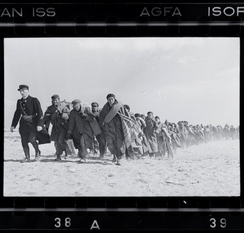 E BARCARÈS, France—Exiled Republicans being marched on the beach from one internment camp to another area by a French policeman, March 1939.