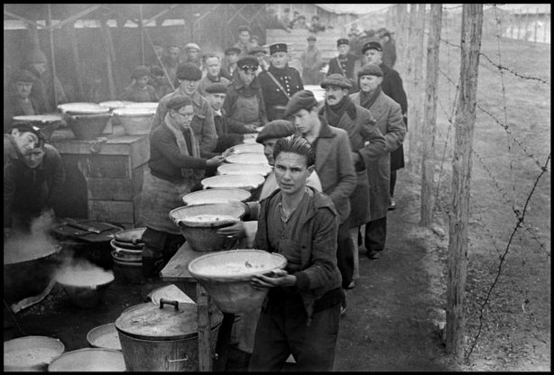 BRAM, France—A line of men receiving food in an internment camp for Republican exiles, March 1939. © ROBERT CAPA © 2001 By Cornell Capa / Magnum Photos
