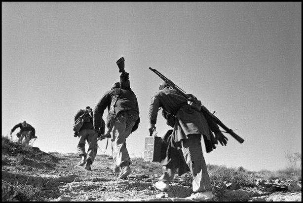 SPAIN—Republican soldiers storming forward in jumps, at Rio Segre, on the Aragon front, near Fraga, Nov. 7, 1938. © ROBERT CAPA © 2001 By Cornell Capa / Magnum Photos