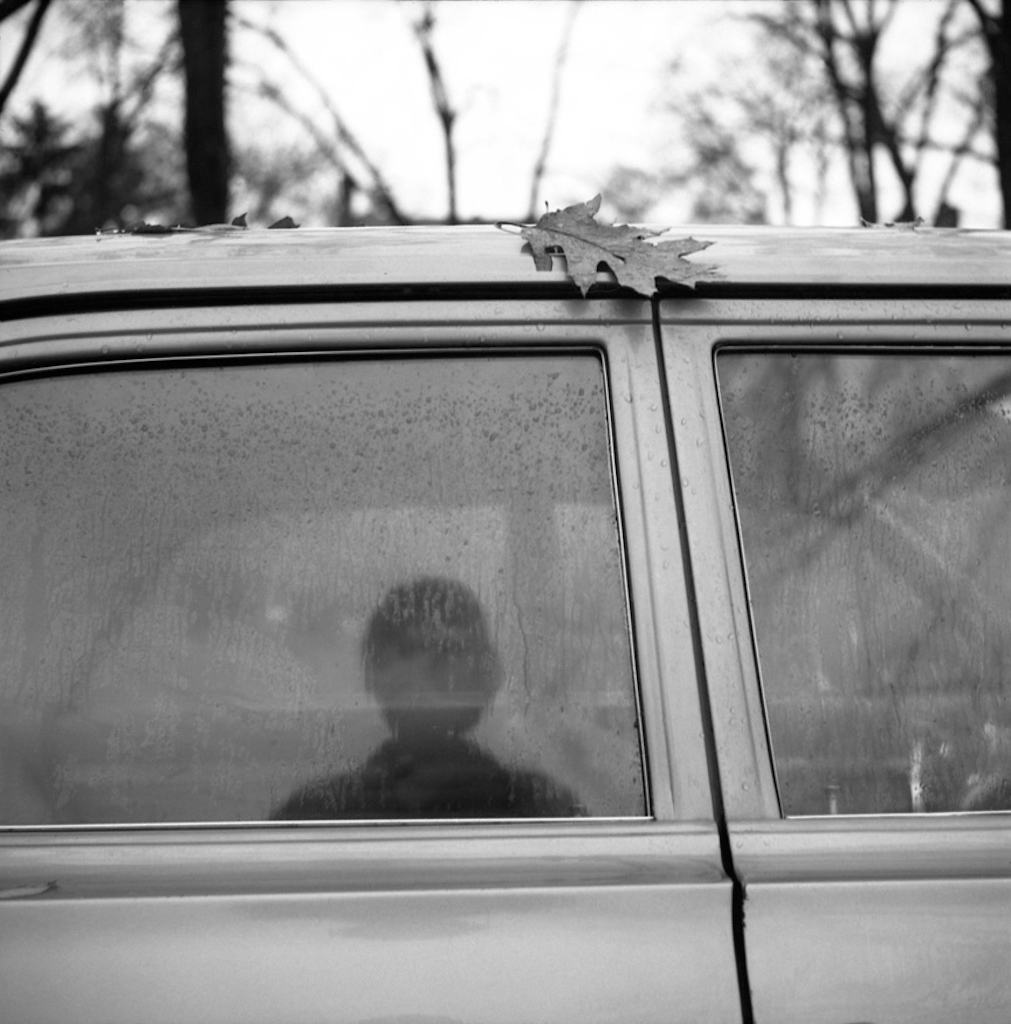 Self-Portrait (Car Window Reflection with Leaf), ca. 1967 © Vivian Maier