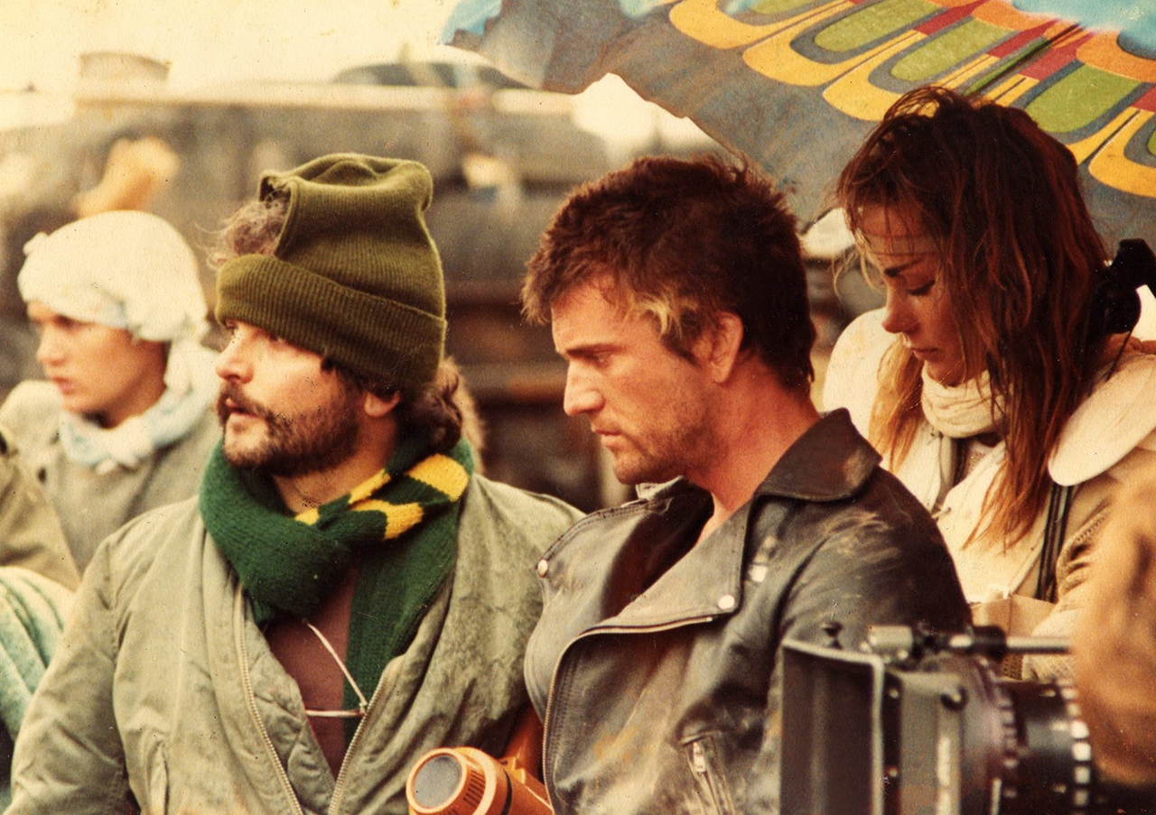 George Miller, Mel Gibson & Virginia Hey on the set of Road Warrior (1981).